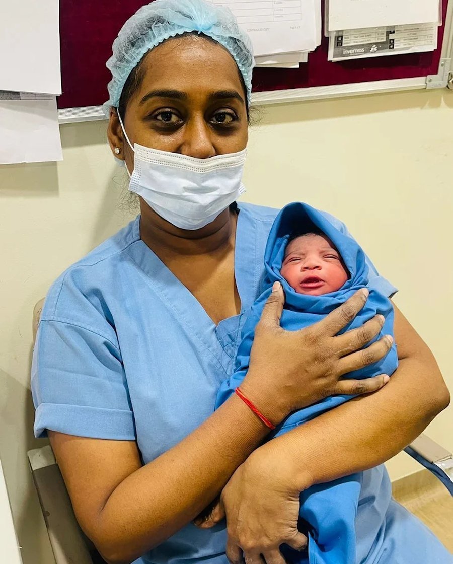 A newborn wrapped and held safely in the moments after delivery
